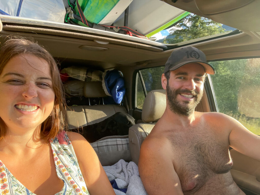 Samara and Myles smiling in our 4Runner driving around Johnson lake