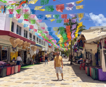 A photo of a man standing on Quinta Ave in Playa del Carmen Mexico