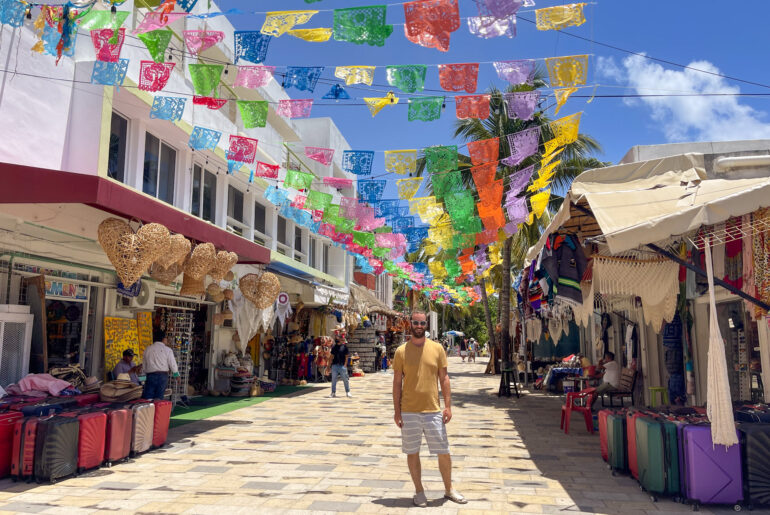 A photo of a man standing on Quinta Ave in Playa del Carmen Mexico