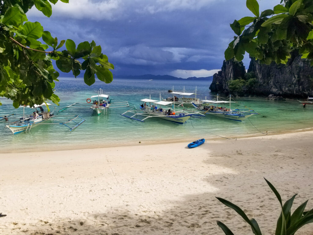 catamaran boats with a nice sandy beach and storm