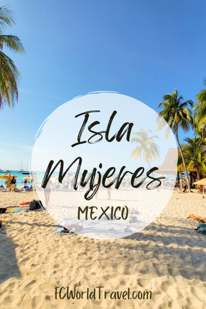 A photo of Playa Norte, the best beach in Isla Mujeres Mexico. A white sand beach with palm trees make for perfect island vibes with the Caribbean Sea in the background.