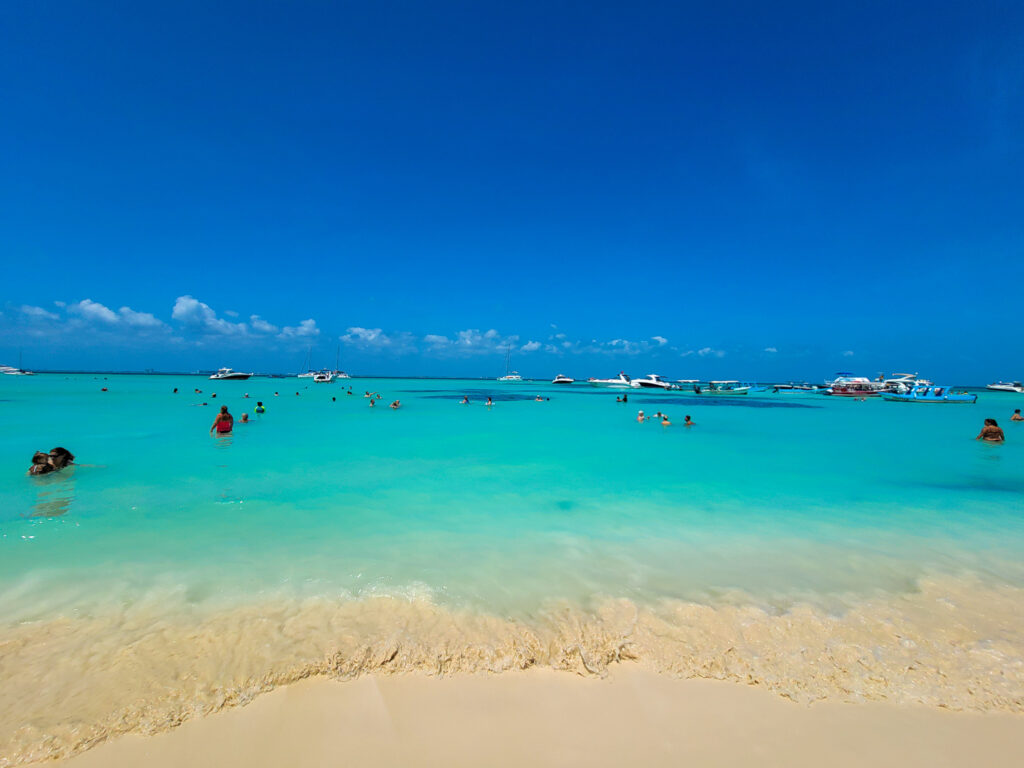 Turquoise water of the Caribbean Sea meeting a white sand beach of Playa Norte on Isla Mujeres