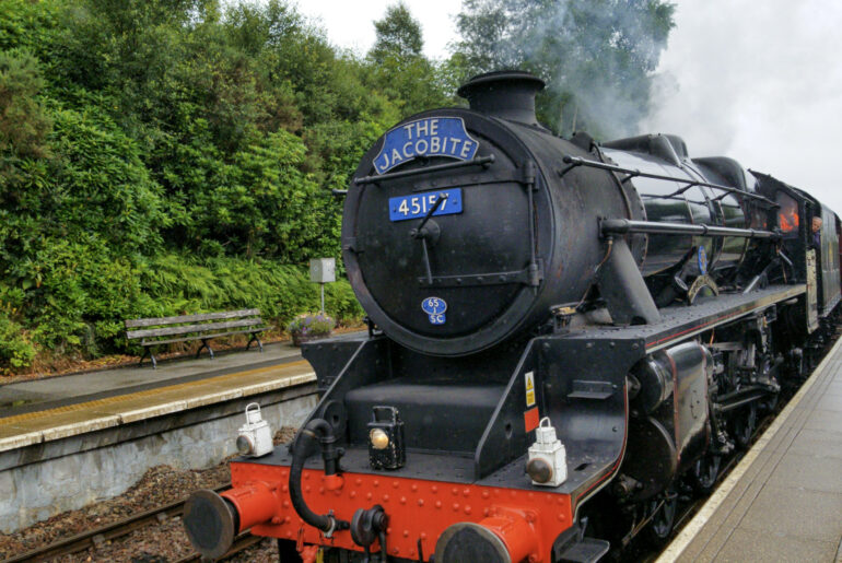 The Jacobite in Scotland is the famous Hogwarts Express from Harry Potter, the photo shows the steam train entering the station. Ride this on a trip to Scotland